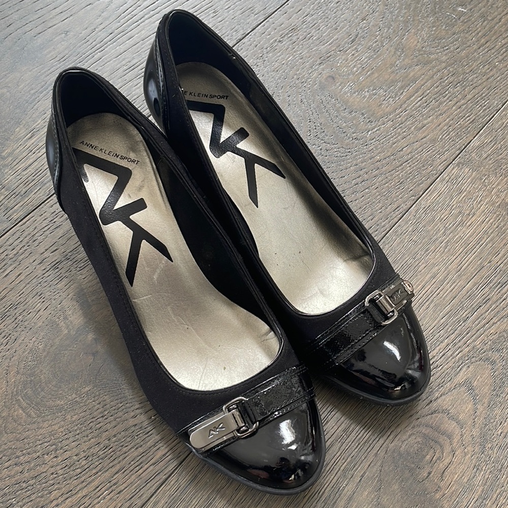 Anne Klein Sport black wedge shoe. 8.5”. Patent leather toe area w buckle.